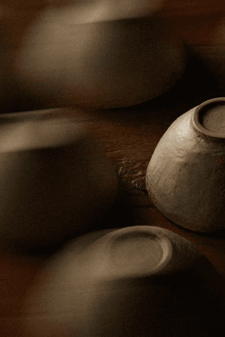 Handmade ceramic bowls on a dark wooden table
